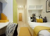 Thumbnail 14 of 50 - a bedroom with a bed and desk in a 555 waverly unit