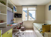 Thumbnail 35 of 50 - a room with a bed and a desk with a chair