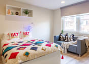 Thumbnail 45 of 50 - a bedroom with a bed and a chair in a 555 waverly unit