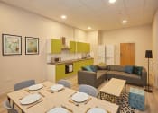 Thumbnail 13 of 50 - a living room and kitchen with a dining table and chairs