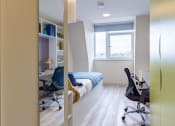 Thumbnail 19 of 50 - a bedroom with a bed and desk in a 555 waverly unit