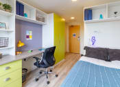 Thumbnail 20 of 50 - a room with a bed and a desk