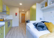 Thumbnail 23 of 50 - a bedroom with a bed and a desk in a room