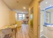 Thumbnail 24 of 50 - a kitchen and living room with yellow walls and hardwood floors