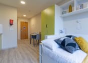Thumbnail 26 of 50 - a bedroom with a bed and desk in a 555 waverly unit