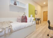 Thumbnail 28 of 50 - a bedroom with a bed and desk in a 555 waverly unit