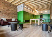 Thumbnail 2 of 49 - a room with green walls and a brick wall with a table and chairs in it