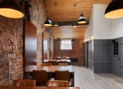 Thumbnail 12 of 49 - a room with wooden tables and chairs and brick walls