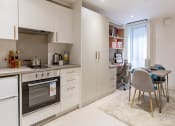 Thumbnail 37 of 49 - a kitchen and dining area in a 555 waverly unit