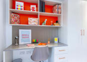 Thumbnail 30 of 49 - a desk with a chair and a shelf above it