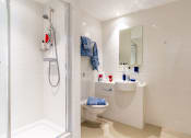 Thumbnail 35 of 49 - a bathroom with a shower sink and toilet