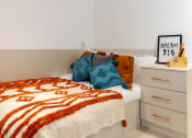 Thumbnail 39 of 49 - a bedroom with a bed and a dresser