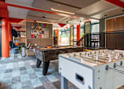 Thumbnail 1 of 51 - Two games tables in a room, one pool table and
