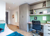 Thumbnail 7 of 48 - A room with a desk and a chair.