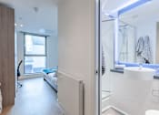 Thumbnail 9 of 48 - A bathroom with a white sink and a glass shower door.