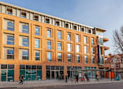 Thumbnail 19 of 48 - A large building with a lot of windows and a sign that says "Exciting New Relief".