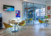 Thumbnail 46 of 48 - A conference room with a table, chairs and a television on the wall.