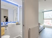 Thumbnail 33 of 48 - A bathroom with a sink, mirror, and a window.