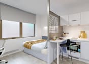 Thumbnail 13 of 21 - A modern bedroom with a built-in desk and chair.