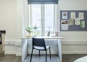 Thumbnail 10 of 59 - a desk under a window with a chair and pinboard