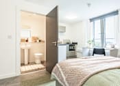 Thumbnail 7 of 59 - bed with green bedding looking towards an en-suite bathroom with toilet and sink