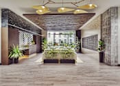 Thumbnail 1 of 17 - A modern hallway with wooden floors and a long table with plants on it.