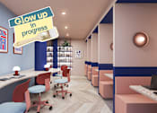Thumbnail 8 of 21 - A modern office space with a sign that says "Glow up in progress".