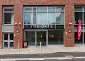 Thumbnail 2 of 51 - The front of a building with a sign that says The Gate.