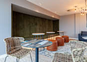 Thumbnail 5 of 36 - A room with a round table and chairs.