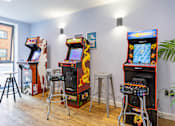 Thumbnail 6 of 35 - A row of arcade games are lined up in a room.