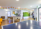 Thumbnail 9 of 35 - A room with a pool table and a foosball table.