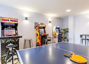 Thumbnail 8 of 35 - A ping pong table with a yellow paddle on it.
