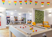 Thumbnail 4 of 35 - A pool table is in the middle of a room with a green wall and a fire extinguisher on the wall.