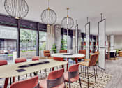 Thumbnail 2 of 17 - A modern dining room with a round table and chairs.