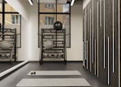 Thumbnail 29 of 34 - A gym with a white mat and a black ball on it.
