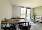 Thumbnail 34 of 41 - A modern dining room with a large table and chairs.