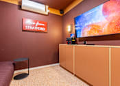 Thumbnail 27 of 56 - A room with a red wall and a sign that says "Live from Stratford" is shown.