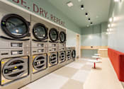 Thumbnail 51 of 56 - A row of washing machines in a laundromat.