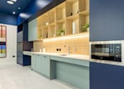 Thumbnail 54 of 56 - A modern kitchen with a blue and white color scheme.