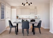 Thumbnail 2 of 11 - a kitchen and dining room with a table and chairs