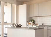 Thumbnail 4 of 11 - a kitchen with white cabinets and a white counter top