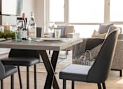 Thumbnail 3 of 11 - a dining room with a table and chairs and a living room