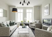 Thumbnail 14 of 22 - a living room with couches and chairs and a coffee table
