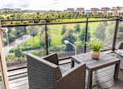Thumbnail 3 of 11 - a balcony or terrace with a table and chairs