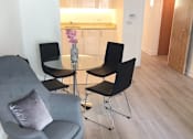 Thumbnail 16 of 16 - a living room with a couch and a chair and a table