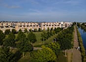 Thumbnail 6 of 11 - an aerial view of a park with trees and buildings in the background