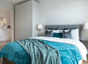 Thumbnail 1 of 10 - a bedroom with a bed and a ensuite bathroom