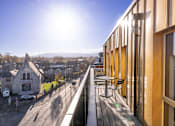 Thumbnail 1 of 23 - a balcony with a view of a city and a building