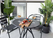 Thumbnail 6 of 10 - a small patio with a table and chairs and glasses of wine