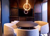 Thumbnail 17 of 23 - a dining room with a table and chairs